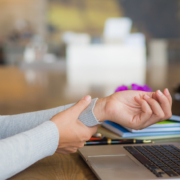Woman holding wrist suffering from carpal tunnel syndrome, oteoarthritis, or wrist truama.