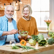 Older couple cooking a healthy meal to perserve their healthspan with nutrution.