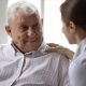 Young female physician talking to a senior man